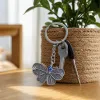 Silver butterfly-shaped keychain with blue evil eye bead decoration, fashionable and personalized pendant gift details Picture